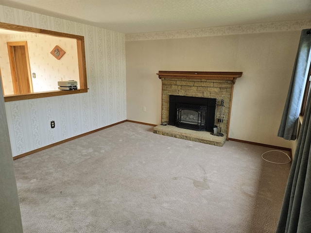 9 Mariette Dr, Portsmouth, NH 03801 - unfurnished living room with a stone fireplace, carpet floors, and wallpapered walls