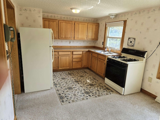 9 Mariette Dr, Portsmouth, NH 03801 - kitchen with gas range, freestanding refrigerator, wallpapered walls, light carpet, and light countertops
