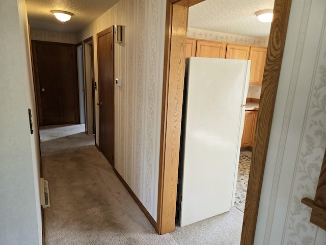 9 Mariette Dr, Portsmouth, NH 03801 - corridor featuring light carpet, a textured ceiling, and wallpapered walls