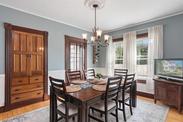 17 Brown Ave, Saint Albans City, VT 05478 - dining room featuring a chandelier, light wood-type flooring, wainscoting, and ornamental molding