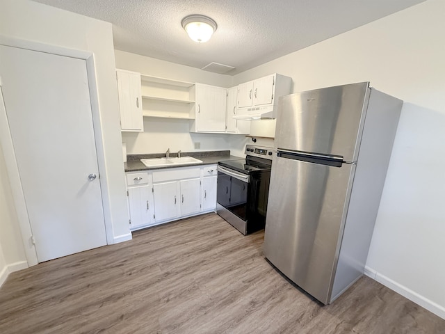18 Gould Ave Unit 1, Meredith, NH 03253 - kitchen featuring appliances with stainless steel finishes, under cabinet range hood, dark countertops, open shelves, and light wood-style flooring