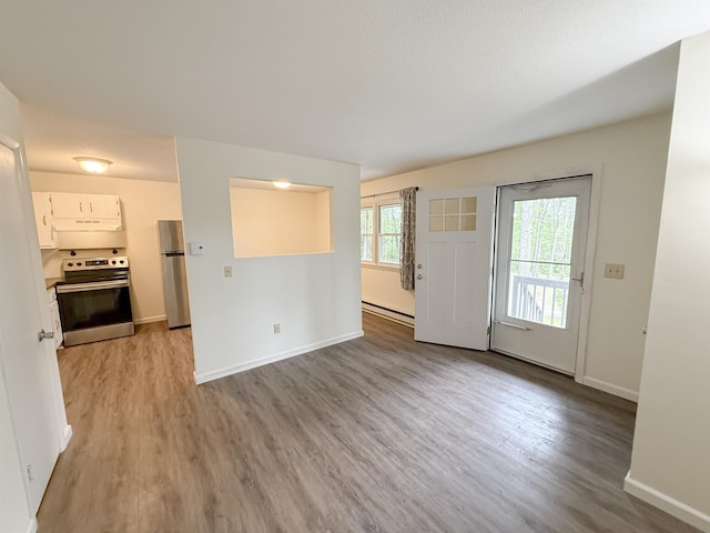18 Gould Ave Unit 1, Meredith, NH 03253 - unfurnished living room featuring baseboard heating and light wood finished floors