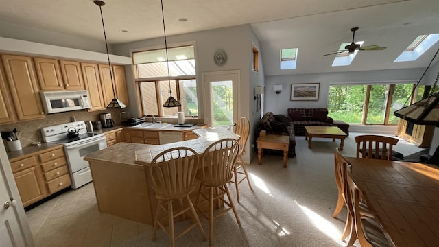 248 Club Sugarbush Ext Unit 18, Warren, VT 05674 - kitchen featuring white appliances, a skylight, light brown cabinetry, vaulted ceiling, and open floor plan