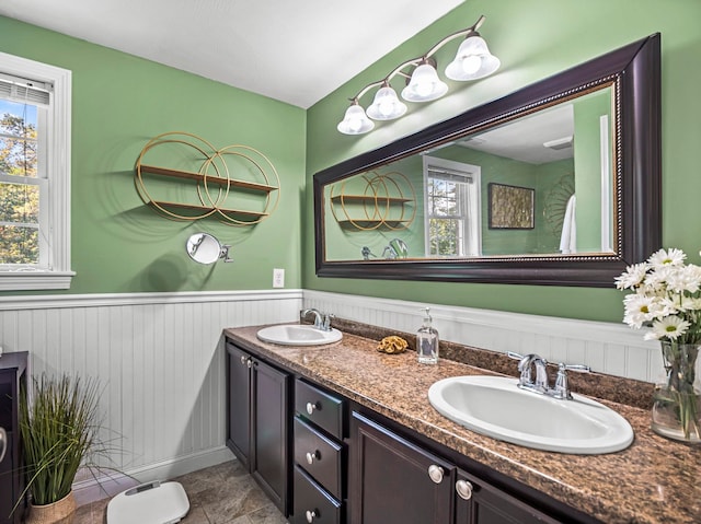 20 Lawrence Rd, Derry, NH 03038 - bathroom featuring double vanity, plenty of natural light, and a wainscoted wall