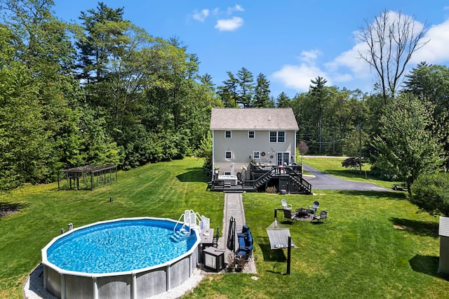 20 Lawrence Rd, Derry, NH 03038 - rear view of property with an outdoor pool, a deck, stairs, an outdoor fire pit, and a yard