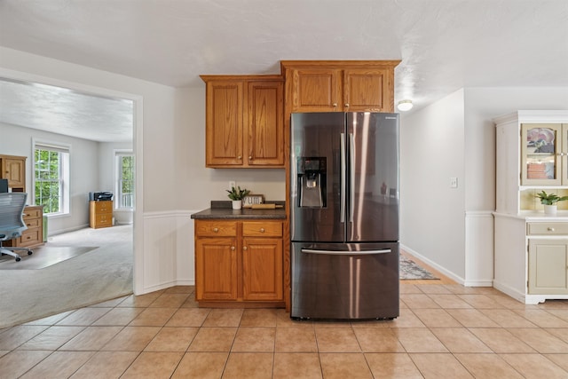 60 Lady Slipper Ln, Chester, NH 03036 - kitchen with stainless steel fridge with ice dispenser, light tile patterned flooring, brown cabinets, and an office area