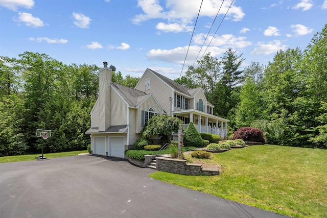 60 Lady Slipper Ln, Chester, NH 03036 - view of side of home with an attached garage, a lawn, driveway, and a chimney