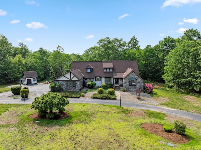 19 Hardwood Rd, Windham, NH 03087 - tudor house featuring stone siding, curved driveway, an outbuilding, and a front lawn