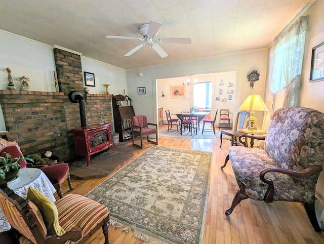 1573 US Route 5 S, Barnet, VT 05821 - living area featuring crown molding, a wood stove, hardwood / wood-style floors, and ceiling fan