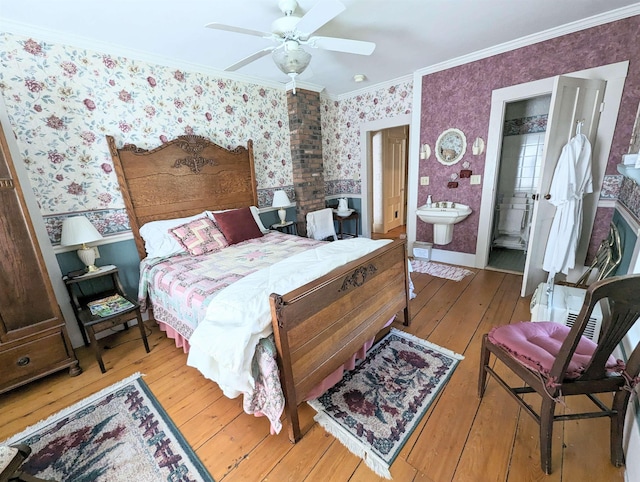 1573 US Route 5 S, Barnet, VT 05821 - bedroom with wallpapered walls, crown molding, light wood finished floors, ensuite bath, and a ceiling fan