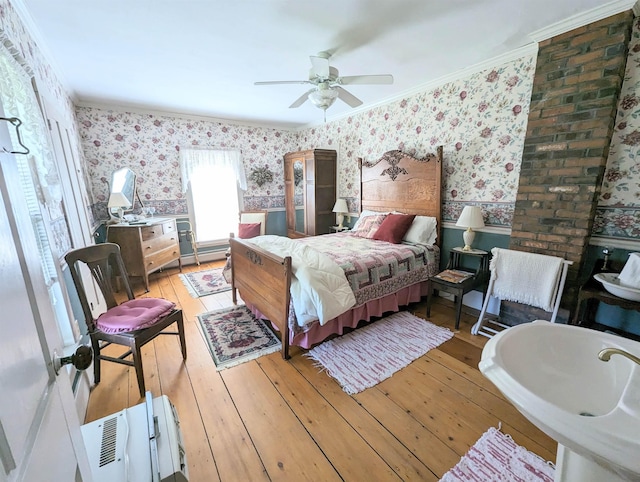 1573 US Route 5 S, Barnet, VT 05821 - bedroom featuring wallpapered walls, wainscoting, light wood-style flooring, crown molding, and a ceiling fan
