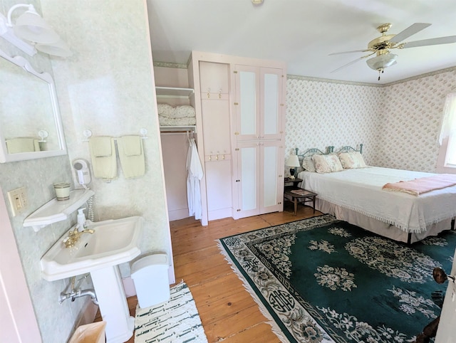 1573 US Route 5 S, Barnet, VT 05821 - bedroom featuring hardwood / wood-style floors, wallpapered walls, and ceiling fan