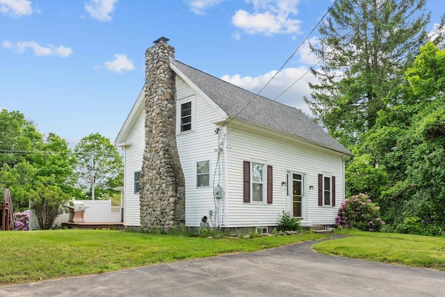 2 Brown Rd, Windham, NH 03087 - view of front facade featuring a chimney, a front yard, a deck, and roof with shingles