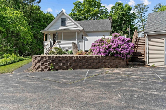 2 Brown Rd, Windham, NH 03087 - view of front facade with stairs, covered porch, and roof with shingles