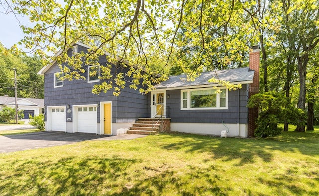 19 Harding Rd, Portsmouth, NH 03801 - tri-level home with asphalt driveway, a chimney, an attached garage, and a front yard