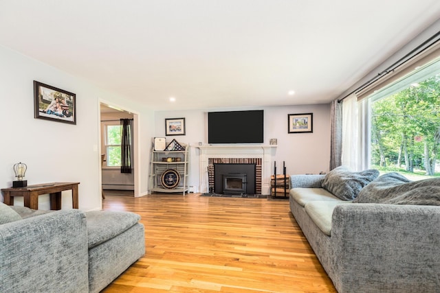 19 Harding Rd, Portsmouth, NH 03801 - living area with light wood finished floors, a baseboard radiator, a brick fireplace, and recessed lighting