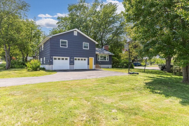 19 Harding Rd, Portsmouth, NH 03801 - view of home's exterior with asphalt driveway, a garage, a yard, and a chimney