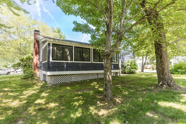 19 Harding Rd, Portsmouth, NH 03801 - back of house with a chimney, a sunroom, and a lawn