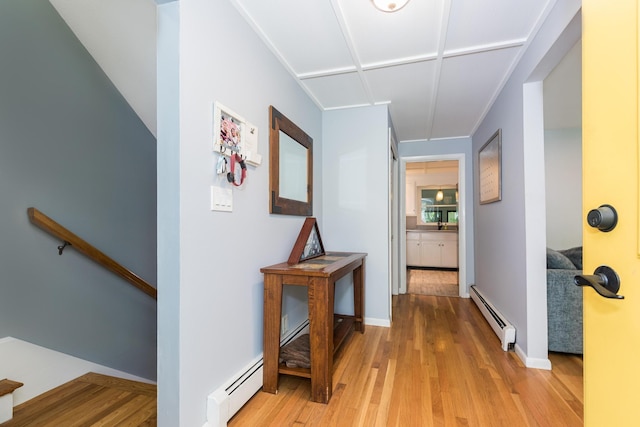 19 Harding Rd, Portsmouth, NH 03801 - corridor featuring a baseboard heating unit, light wood-style floors, and an upstairs landing