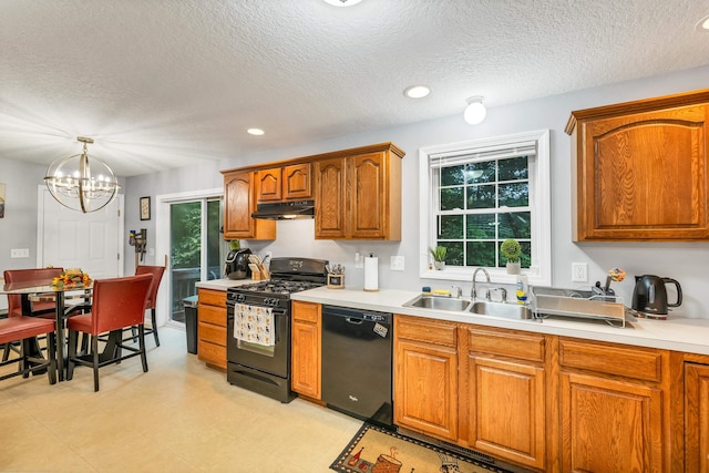 69A Windham Rd Unit A, Hudson, NH 03051 - kitchen featuring black appliances, under cabinet range hood, light countertops, plenty of natural light, and a textured ceiling