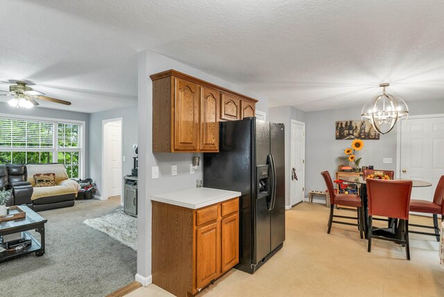69A Windham Rd Unit A, Hudson, NH 03051 - kitchen with black refrigerator with ice dispenser, brown cabinetry, light countertops, ceiling fan, and a chandelier
