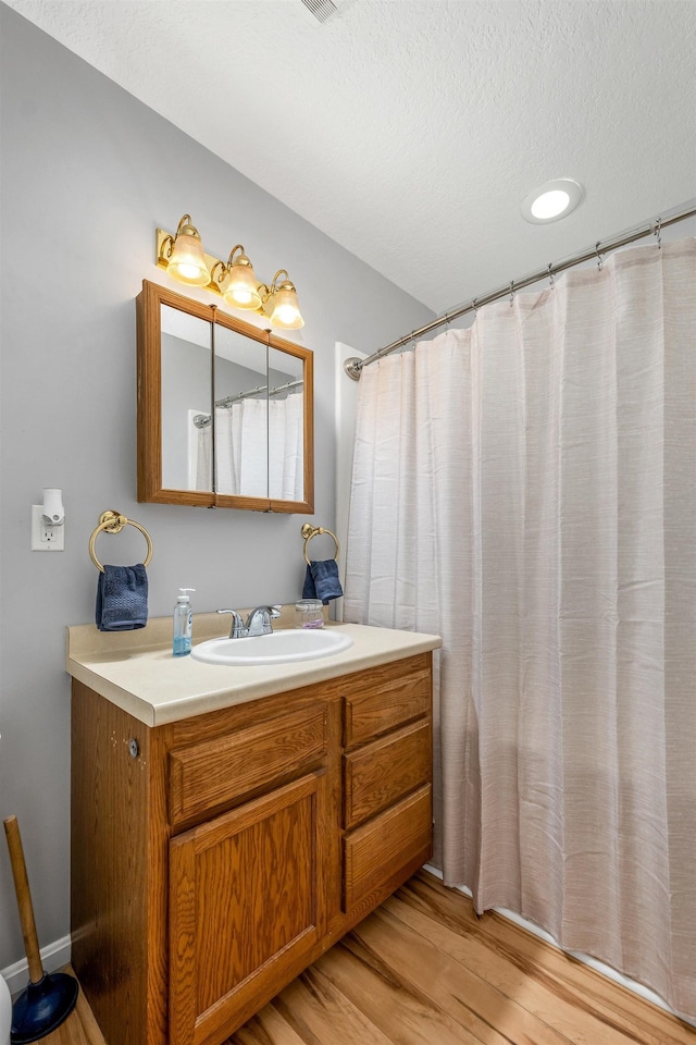 69A Windham Rd Unit A, Hudson, NH 03051 - full bathroom featuring wood finished floors, vanity, a textured ceiling, and a shower with curtain