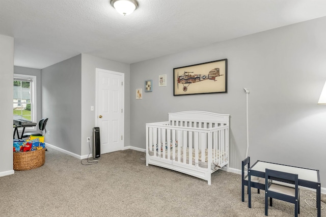 69A Windham Rd Unit A, Hudson, NH 03051 - bedroom with carpet floors, a textured ceiling, and a nursery area