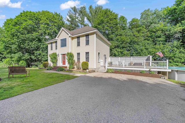 12 Lawrence St, Derry, NH 03038 - colonial inspired home featuring a deck, a front yard, and an outdoor pool