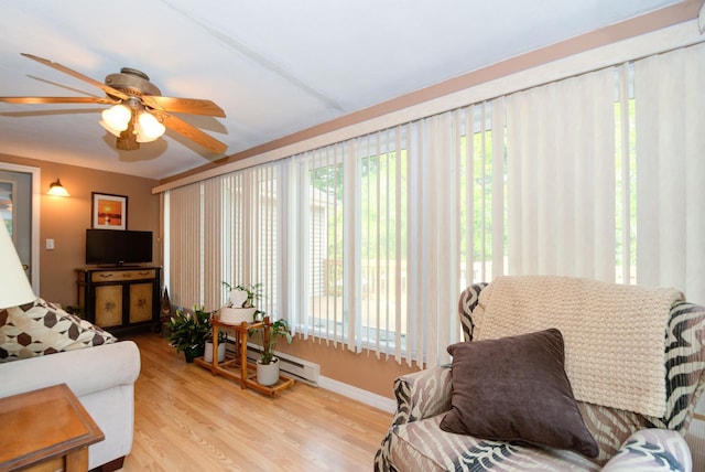 27 Meisner Rd, Salem, NH 03079 - living area with a baseboard heating unit, healthy amount of natural light, ceiling fan, and wood finished floors