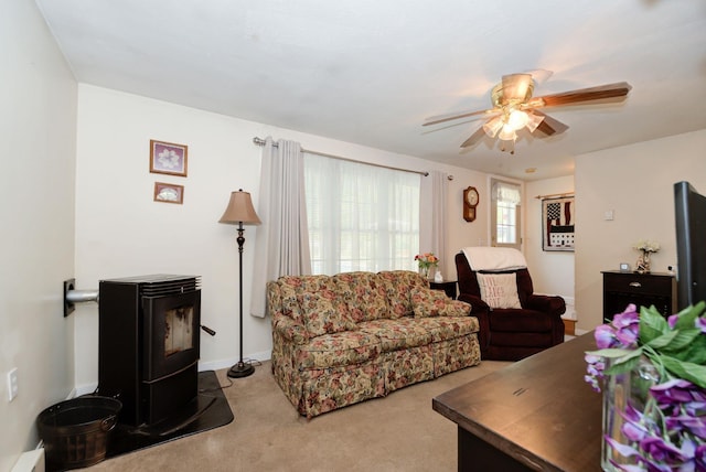 27 Meisner Rd, Salem, NH 03079 - living area featuring a wood stove, ceiling fan, and carpet flooring