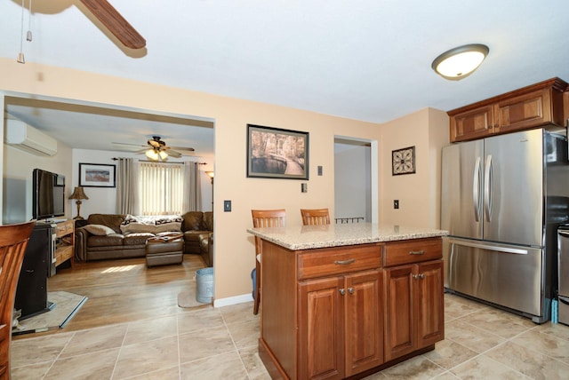 27 Meisner Rd, Salem, NH 03079 - kitchen featuring freestanding refrigerator, ceiling fan, a wall mounted air conditioner, light stone countertops, and brown cabinets