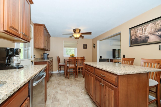 27 Meisner Rd, Salem, NH 03079 - kitchen with stainless steel dishwasher, a breakfast bar area, an AC wall unit, a ceiling fan, and a center island