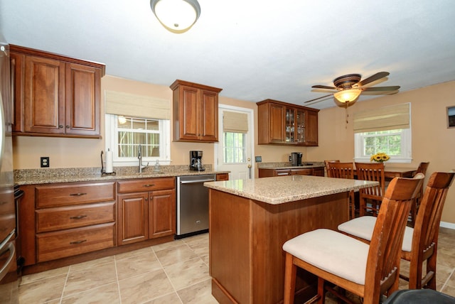 27 Meisner Rd, Salem, NH 03079 - kitchen with dishwasher, a breakfast bar, brown cabinetry, ceiling fan, and plenty of natural light