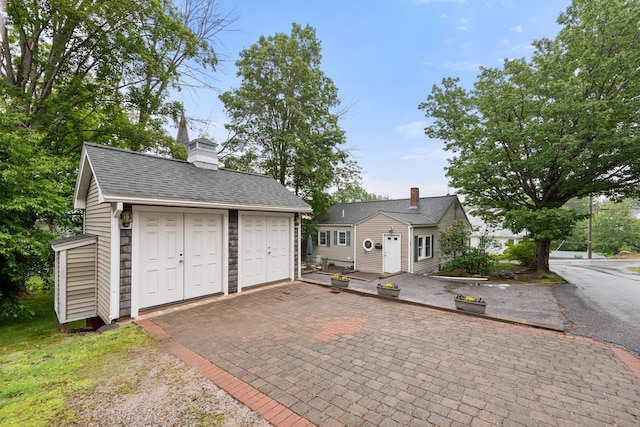 10 Prospect St, Bristol, NH 03222 - view of front of house with an outbuilding and a chimney
