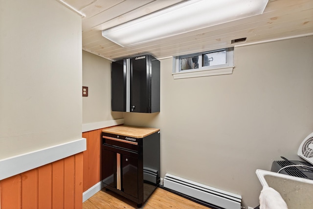 10 Prospect St, Bristol, NH 03222 - bar featuring a baseboard heating unit and light wood-type flooring
