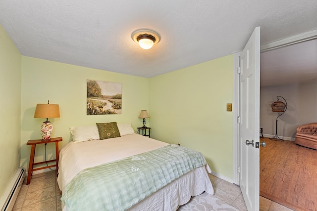 10 Prospect St, Bristol, NH 03222 - bedroom featuring a baseboard heating unit and a textured ceiling
