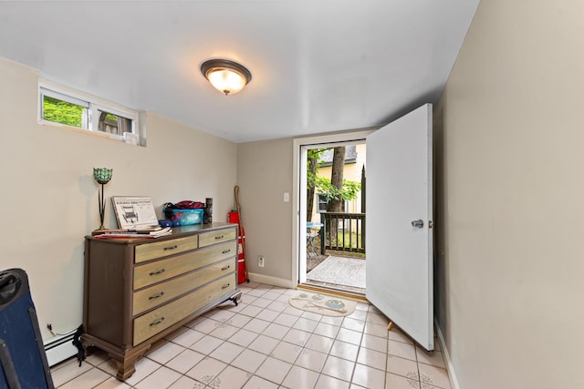 10 Prospect St, Bristol, NH 03222 - bedroom with multiple windows, access to exterior, light tile patterned flooring, and a baseboard heating unit