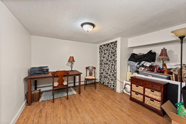 10 Prospect St, Bristol, NH 03222 - office featuring a textured ceiling, wood finished floors, and a baseboard heating unit