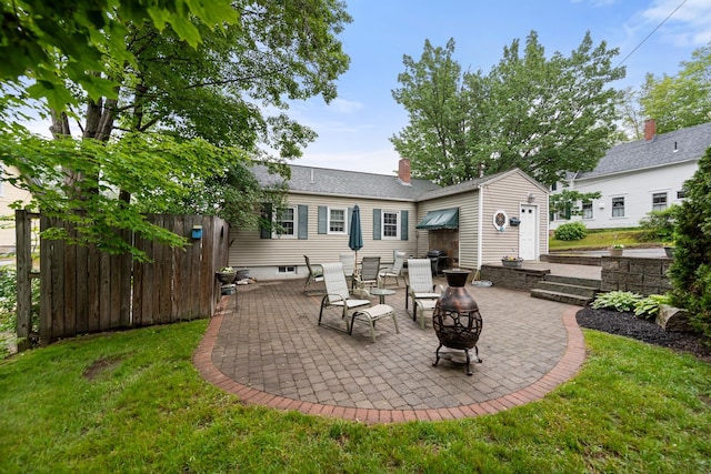 10 Prospect St, Bristol, NH 03222 - rear view of property with a patio area, an outdoor fire pit, a chimney, and a yard