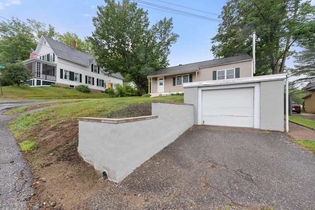 10 Prospect St, Bristol, NH 03222 - view of front of property featuring a garage, driveway, and a front lawn