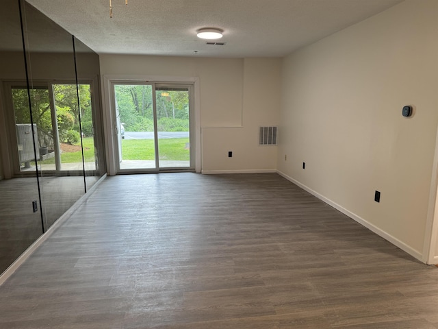 121 Cluff Xing Unit 8, Salem, NH 03079 - spare room with dark wood finished floors and a textured ceiling