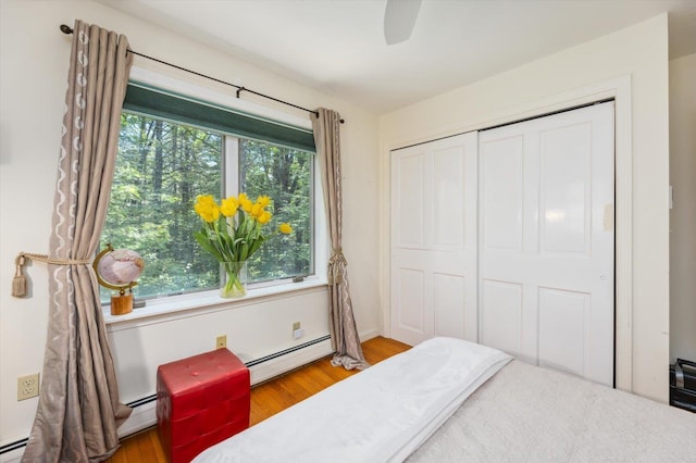 10 Cranberry Rd, Keene, NH 03431 - bedroom with a baseboard radiator, wood finished floors, a closet, and a ceiling fan