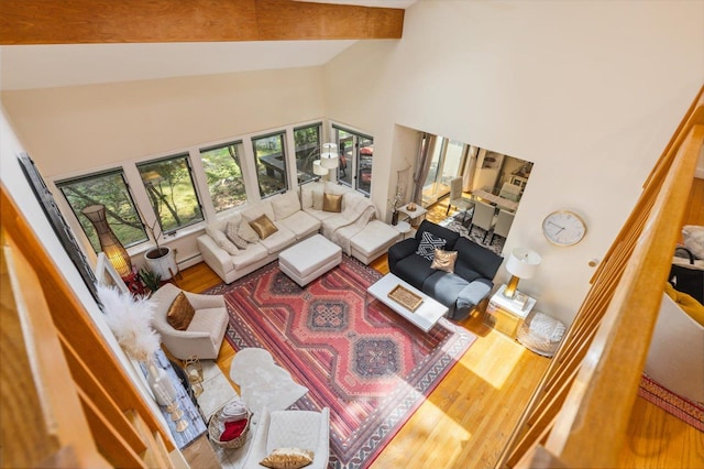 10 Cranberry Rd, Keene, NH 03431 - living room with high vaulted ceiling, beam ceiling, wood finished floors, and a baseboard heating unit