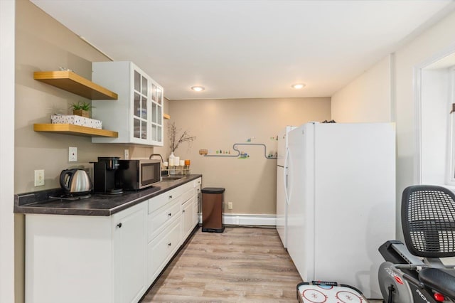10 Cranberry Rd, Keene, NH 03431 - kitchen with freestanding refrigerator, stainless steel microwave, dark countertops, baseboard heating, and light wood-style flooring