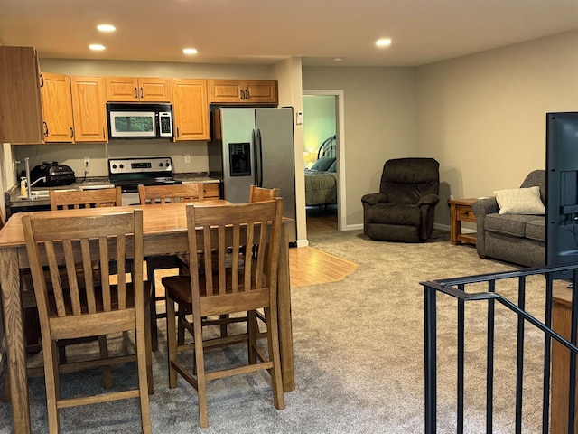 149 Sleepy Hollow Rd, Wakefield, NH 03830 - kitchen featuring appliances with stainless steel finishes, light carpet, recessed lighting, dark countertops, and open floor plan
