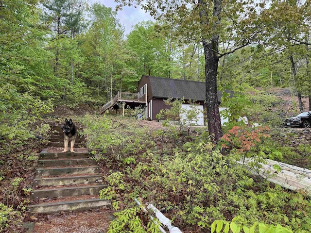 149 Sleepy Hollow Rd, Wakefield, NH 03830 - view of yard with stairs, a view of trees, and a wooden deck