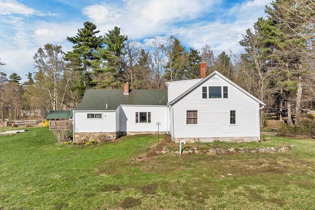 45 Effingham Rd, Ossipee, NH 03864 - back of house featuring a chimney, a lawn, and a shingled roof