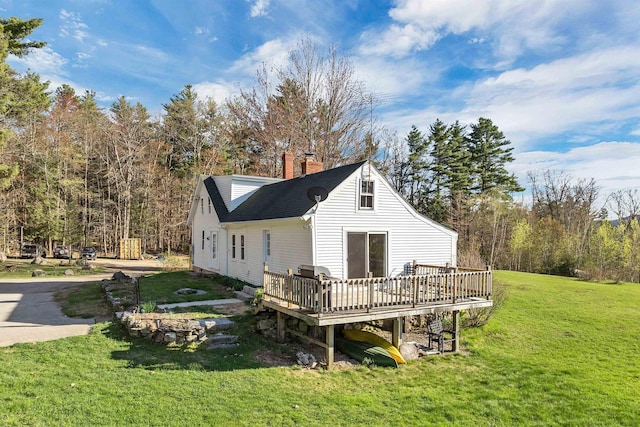 45 Effingham Rd, Ossipee, NH 03864 - back of property featuring a wooden deck, a yard, a chimney, and roof with shingles