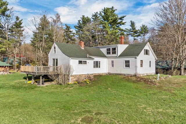 45 Effingham Rd, Ossipee, NH 03864 - rear view of property with a chimney, a wooden deck, a yard, and roof with shingles