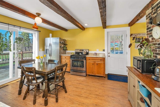 45 Effingham Rd, Ossipee, NH 03864 - kitchen featuring appliances with stainless steel finishes, beam ceiling, light wood-style flooring, brown cabinets, and light stone countertops